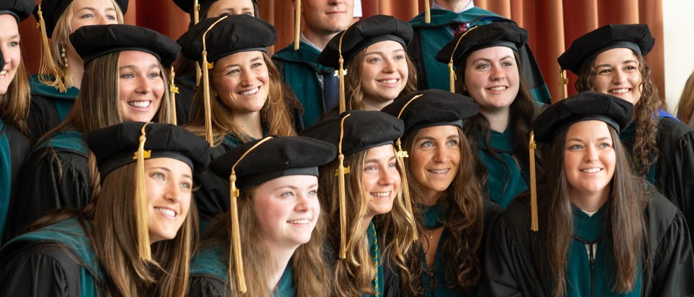 A group of UNE graduates pose for a photo