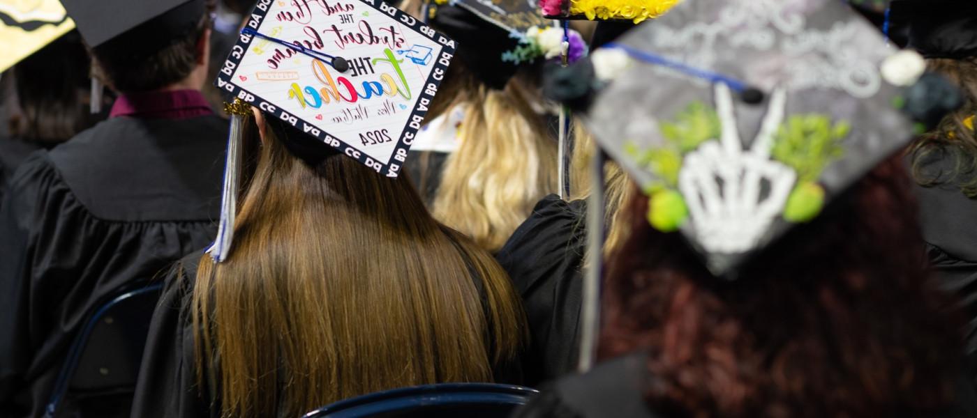 A photo of graduates' caps from behind 