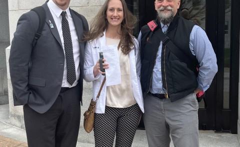 Three representatives from UNE pose outside the Maine State House. They are Ed Cervone, Bethany Miles, and Austin Vaughan..
