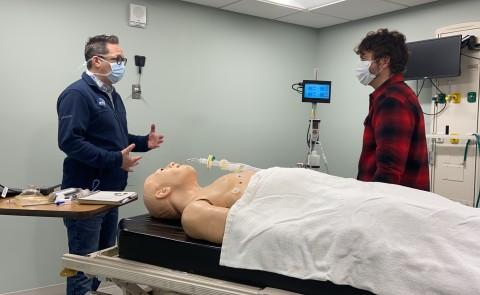 Baxter Academy engineering teacher Jon Amory chats with UNE's Neill Gemmel in the simulation lab